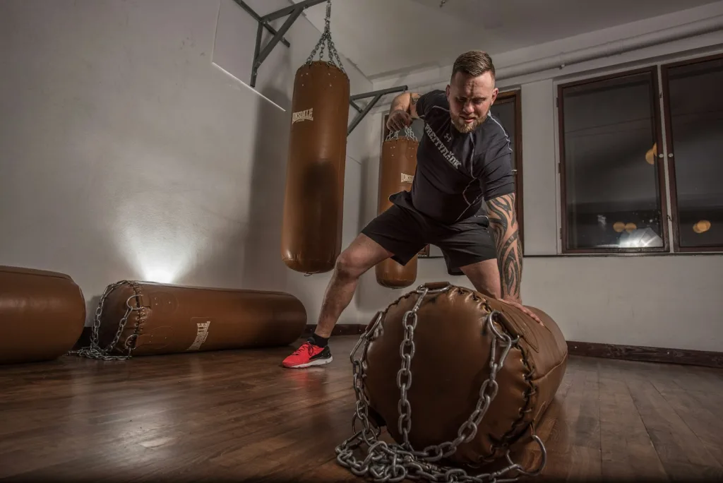 man punching brown leather heavy bag